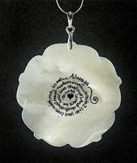 Back of necklace, where an inscription is written in a spiral pattern