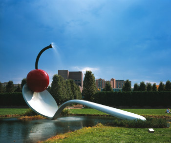 giant spoon with a cherry on the end; it arcs over a little stream