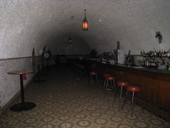 the bar in Wabasha Street Caves, dimly light, with many orbs in the picture