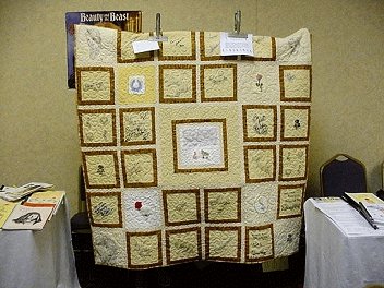 Quilt in yellow, brown, and white. The photo is too small to make out significant details.