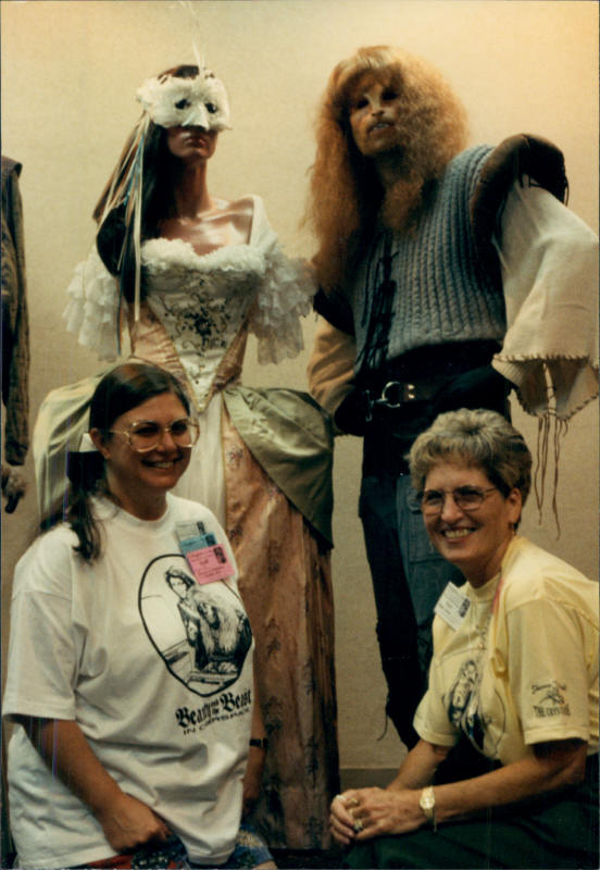 Sandy C. Shelton (Chandler) and JoAnn Grant in front of the costumes of Vincent and Catherine