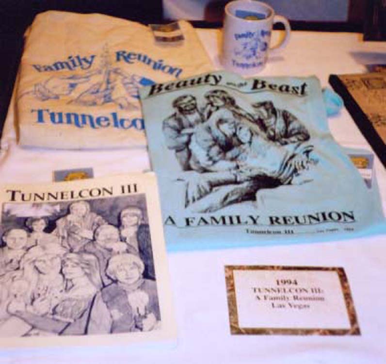a collection of Tunnelcon III items: tote bag, mug, tshirt, conzine