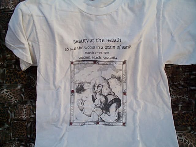 tshirt, white, pencil drawing of Vincent with his hand on Catherine's shoulder. They're both looking at a starfish he's holding. The image is framed with a decorative rectangle with red squares as accent.  Text above the image: Beauty at the Beach | to see the world in a grain of sand | March 27-29, 1998 | Virginia Beach, Virginia