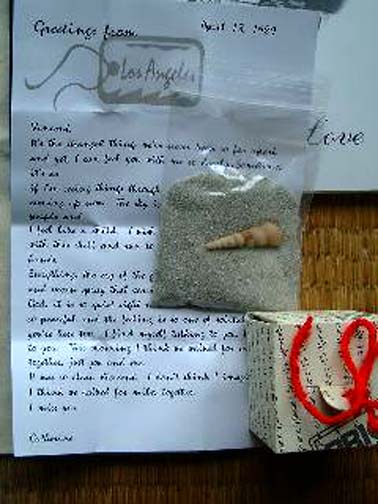 Sigma's letter from Catherine to Vincent, small bag of sand and shell, and gift box