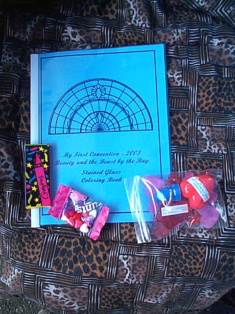 My First Convention - 2003 | Beauty and the Beast by the Bay Stained Glass Coloring Book (hehe), a small pack of crayons, a small package of Runts candies and an assortment of different kinds of hearts
